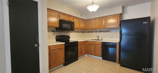 1239 Creve Coeur Crossing Ln Unit C, Chesterfield, MO 63017 - kitchen with black appliances, light countertops, backsplash, brown cabinetry, and hanging light fixtures