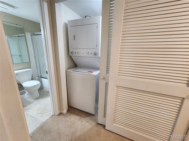 1239 Creve Coeur Crossing Ln Unit C, Chesterfield, MO 63017 - laundry area with stacked washer and clothes dryer, tile patterned floors, and carpet flooring