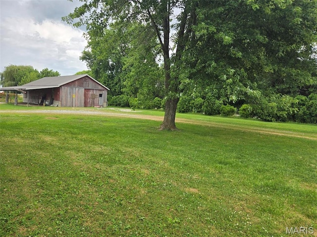 161 W Locust St, Hoyleton, IL 62803 - view of green lawn with a pole building, an outdoor structure, and a detached garage