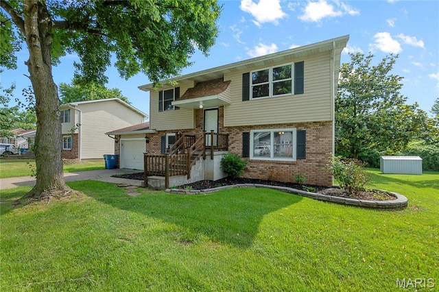 206 Saint Jude, Saint Genevieve, MO 63670 - raised ranch with brick siding, driveway, a front lawn, and a garage