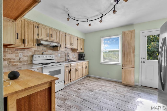 206 Saint Jude, Saint Genevieve, MO 63670 - kitchen with electric stove, under cabinet range hood, light brown cabinets, backsplash, and light wood-style floors