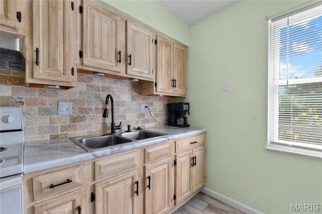206 Saint Jude, Saint Genevieve, MO 63670 - kitchen with light brown cabinetry, decorative backsplash, and stove