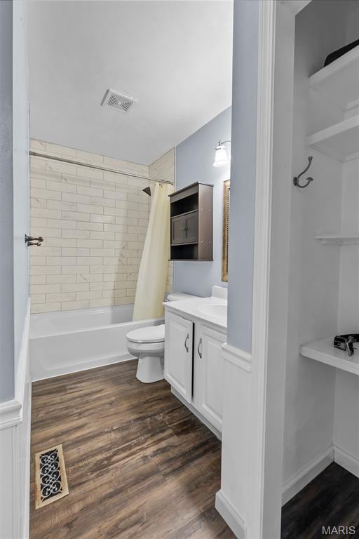 206 Saint Jude, Saint Genevieve, MO 63670 - bathroom featuring vanity, shower / bathtub combination with curtain, and wood finished floors