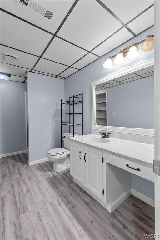 206 Saint Jude, Saint Genevieve, MO 63670 - bathroom with vanity, a paneled ceiling, and wood finished floors