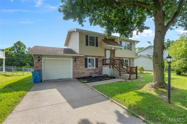 206 Saint Jude, Saint Genevieve, MO 63670 - raised ranch with brick siding, a garage, driveway, and a shingled roof
