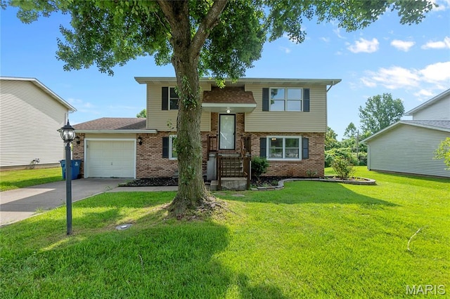 206 Saint Jude, Saint Genevieve, MO 63670 - split foyer home featuring brick siding, driveway, a garage, a front lawn, and roof with shingles