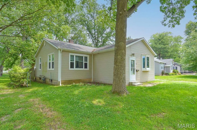 314 N 6th St, Mascoutah, IL 62258 - view of home's exterior with a lawn and a chimney