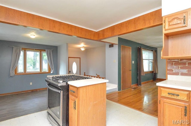 314 N 6th St, Mascoutah, IL 62258 - kitchen featuring gas stove, light flooring, light countertops, and a kitchen island