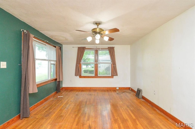 314 N 6th St, Mascoutah, IL 62258 - spare room with hardwood / wood-style flooring, a ceiling fan, and healthy amount of natural light