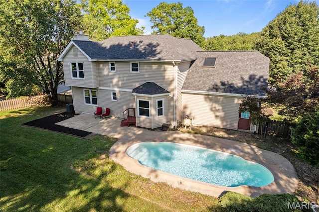 17 Beaujolais Dr, Florissant, MO 63031 - back of house with a patio, a chimney, a fenced backyard, and a shingled roof