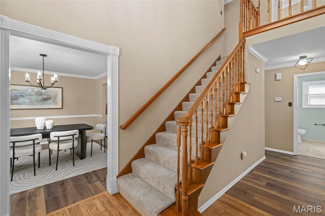 17 Beaujolais Dr, Florissant, MO 63031 - stairs with ornamental molding, wood finished floors, and a chandelier