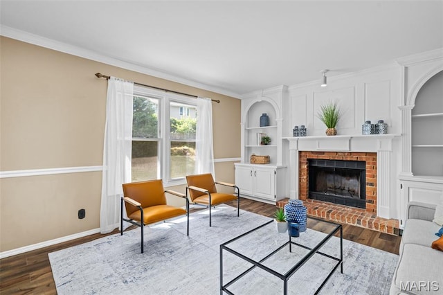 17 Beaujolais Dr, Florissant, MO 63031 - living room featuring dark wood-style flooring, a brick fireplace, built in shelves, and crown molding