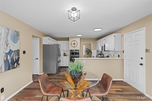 17 Beaujolais Dr, Florissant, MO 63031 - dining area with dark wood finished floors and baseboards