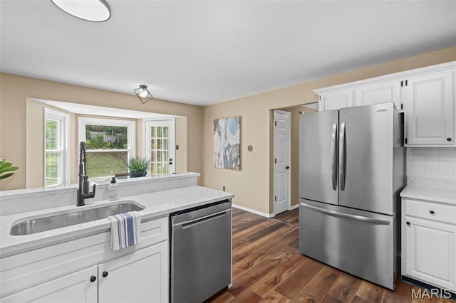 17 Beaujolais Dr, Florissant, MO 63031 - kitchen with appliances with stainless steel finishes, white cabinetry, and dark wood-style flooring