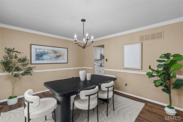17 Beaujolais Dr, Florissant, MO 63031 - dining room with a chandelier, dark wood-type flooring, and ornamental molding