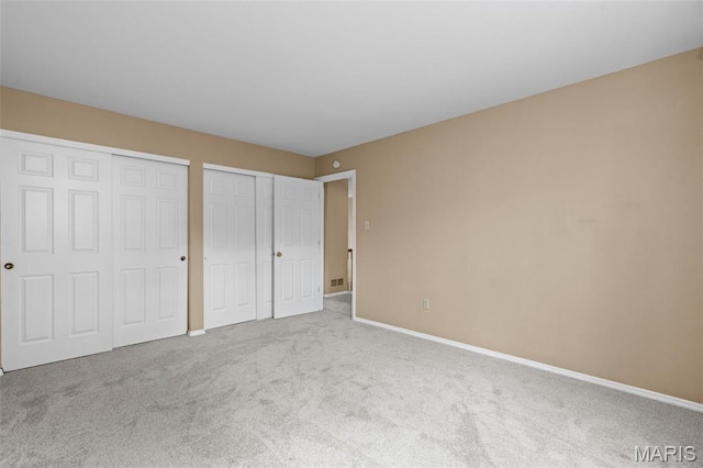 17 Beaujolais Dr, Florissant, MO 63031 - unfurnished bedroom featuring multiple closets and carpet floors