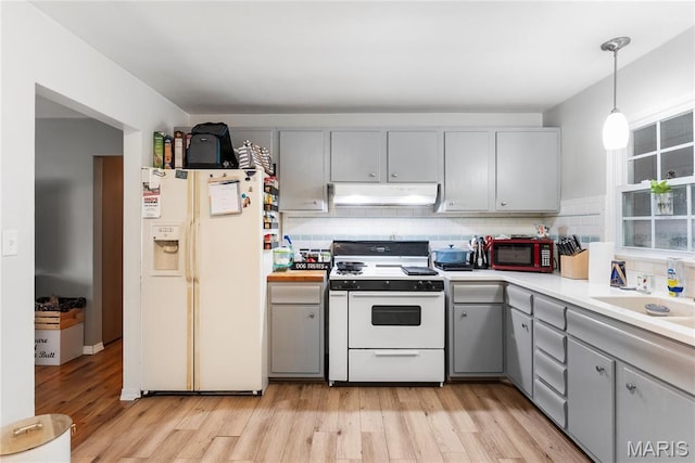 432 N 9th St, Mascoutah, IL 62258 - kitchen with white appliances, gray cabinetry, under cabinet range hood, and decorative backsplash