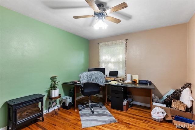432 N 9th St, Mascoutah, IL 62258 - office featuring a ceiling fan, wood finished floors, and a wood stove