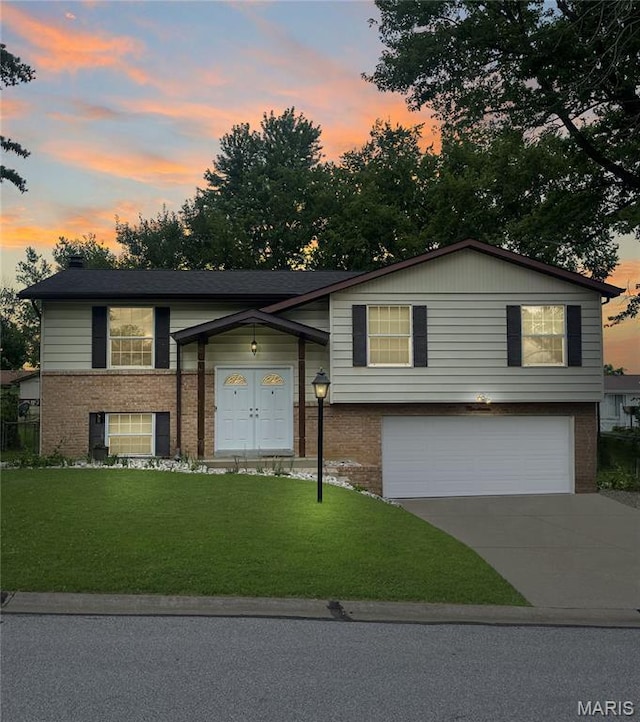 19 Fernwood Dr, Saint Peters, MO 63376 - view of front of home featuring brick siding, a garage, concrete driveway, and a yard