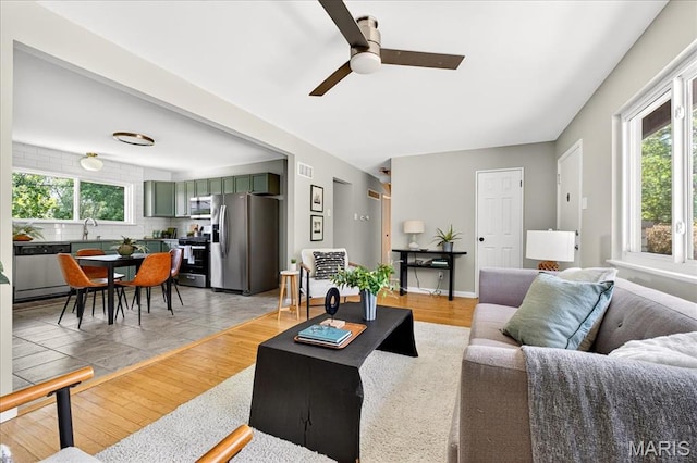 265 Francisca Dr, Florissant, MO 63031 - living area with plenty of natural light and a ceiling fan