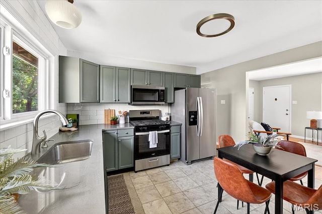 265 Francisca Dr, Florissant, MO 63031 - kitchen featuring appliances with stainless steel finishes, decorative backsplash, and dark countertops
