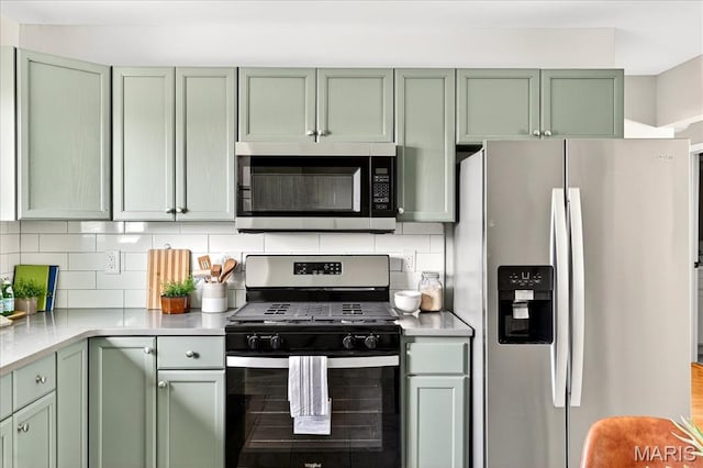 265 Francisca Dr, Florissant, MO 63031 - kitchen with appliances with stainless steel finishes, green cabinets, and light countertops