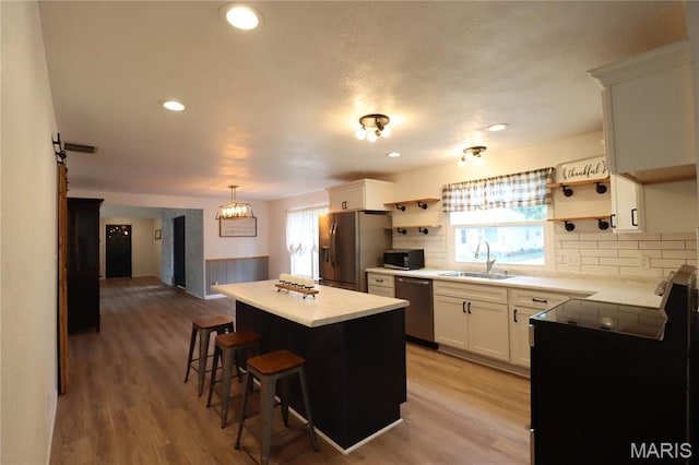 1001 E 2nd St, Saint Peter, IL 62880 - kitchen with appliances with stainless steel finishes, open shelves, a kitchen island, decorative backsplash, and recessed lighting