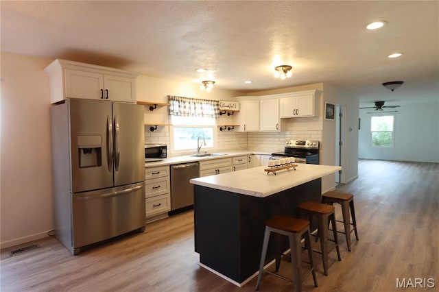 1001 E 2nd St, Saint Peter, IL 62880 - kitchen with appliances with stainless steel finishes, open shelves, light countertops, decorative backsplash, and recessed lighting