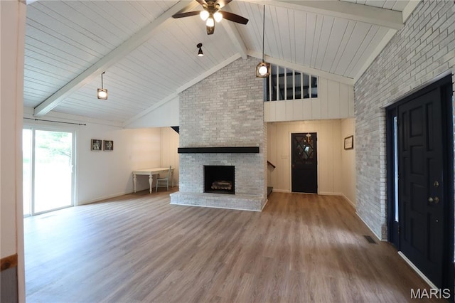 1001 E 2nd St, Saint Peter, IL 62880 - unfurnished living room with a fireplace, ceiling fan, high vaulted ceiling, wood finished floors, and a wood ceiling with exposed beams