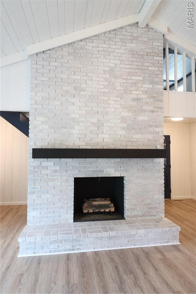 1001 E 2nd St, Saint Peter, IL 62880 - detailed view of beamed ceiling, a fireplace, and wood finished floors