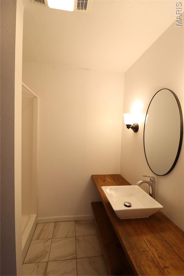 1001 E 2nd St, Saint Peter, IL 62880 - bathroom with marble look tiles, vanity, and a shower