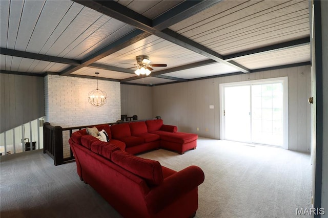 1001 E 2nd St, Saint Peter, IL 62880 - carpeted living area featuring a chandelier, a ceiling fan, beamed ceiling, and wood walls