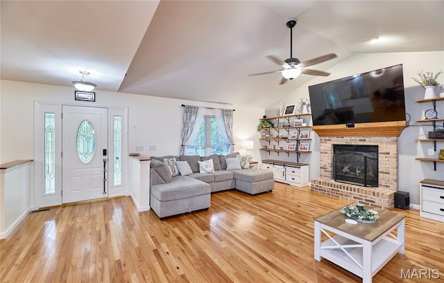 1939 N Rock Church Rd, Troy, MO 63379 - living area with vaulted ceiling, light wood-type flooring, a ceiling fan, and a brick fireplace