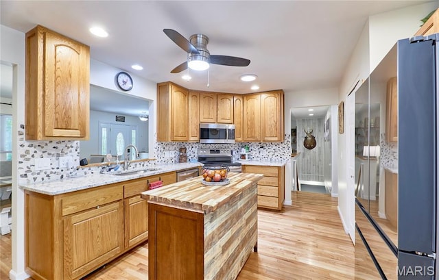 1939 N Rock Church Rd, Troy, MO 63379 - kitchen with stainless steel appliances, butcher block counters, ceiling fan, light wood-style floors, and recessed lighting