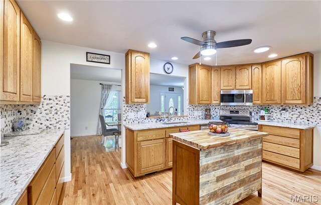 1939 N Rock Church Rd, Troy, MO 63379 - kitchen with stainless steel appliances, light wood-style flooring, backsplash, a ceiling fan, and wood counters
