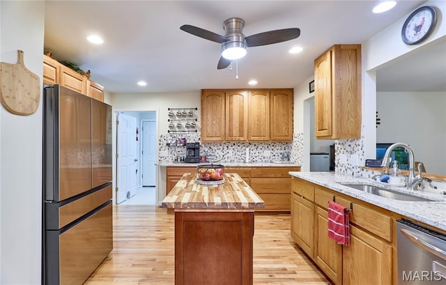 1939 N Rock Church Rd, Troy, MO 63379 - kitchen featuring appliances with stainless steel finishes, butcher block countertops, light wood finished floors, decorative backsplash, and ceiling fan