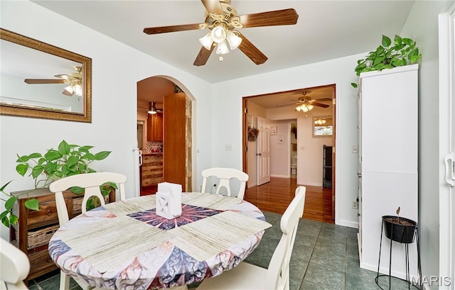 1939 N Rock Church Rd, Troy, MO 63379 - dining area featuring arched walkways, ceiling fan, and dark tile patterned flooring