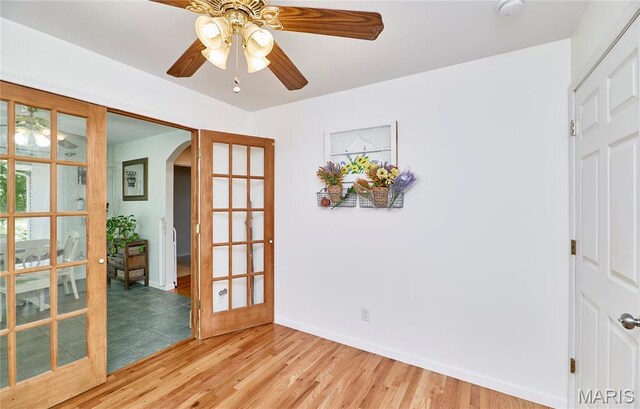 1939 N Rock Church Rd, Troy, MO 63379 - spare room featuring arched walkways, ceiling fan, a smoke detector, and light wood finished floors