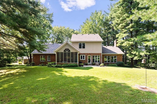 4 Cheshire Ct, Edwardsville, IL 62025 - rear view of property featuring brick siding, a sunroom, a yard, and a chimney