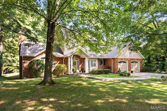 4 Cheshire Ct, Edwardsville, IL 62025 - view of front of property featuring concrete driveway, a garage, a front lawn, brick siding, and a chimney
