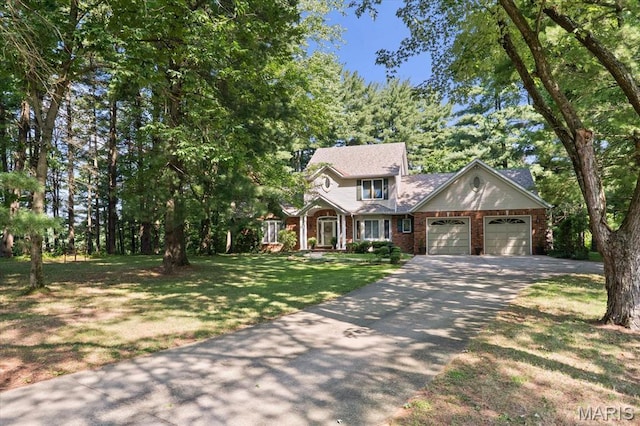 4 Cheshire Ct, Edwardsville, IL 62025 - view of front facade featuring driveway, a garage, a front yard, and brick siding