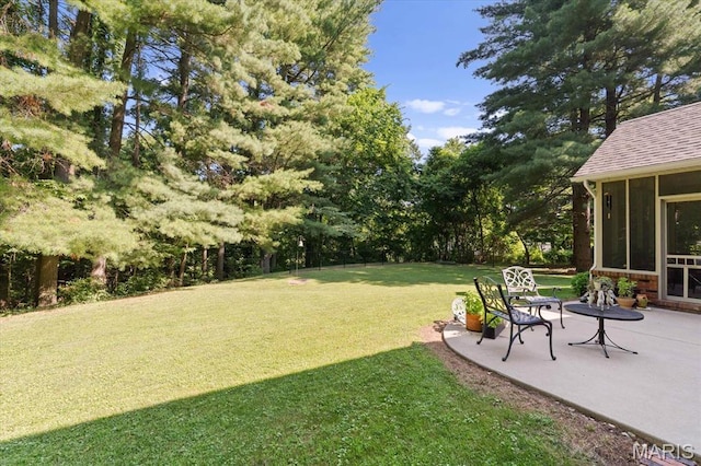 4 Cheshire Ct, Edwardsville, IL 62025 - view of grassy yard with a sunroom, a patio, and view of scattered trees