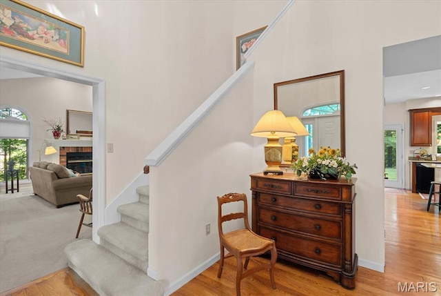 4 Cheshire Ct, Edwardsville, IL 62025 - staircase with a high ceiling, wood finished floors, and a brick fireplace