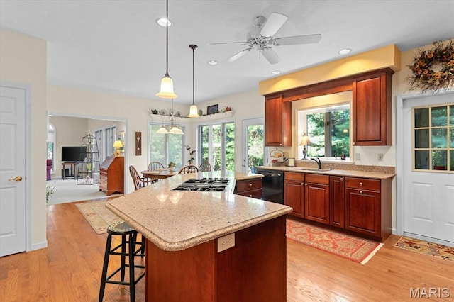 4 Cheshire Ct, Edwardsville, IL 62025 - kitchen featuring black dishwasher, light wood finished floors, stainless steel gas cooktop, a kitchen island, and decorative light fixtures
