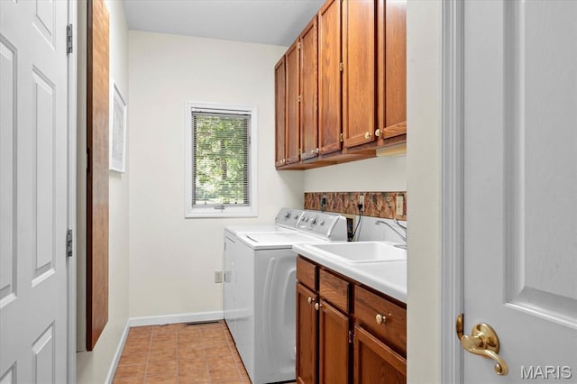 4 Cheshire Ct, Edwardsville, IL 62025 - laundry area with cabinet space, washing machine and dryer, and light tile patterned floors