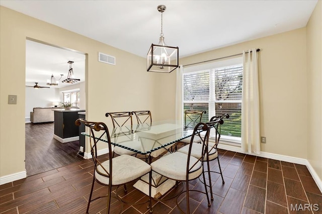 219 Royalltrail Ln, Saint Charles, MO 63368 - dining area with a chandelier, wood tiled floors, and ceiling fan