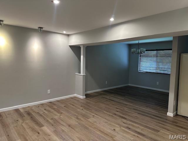 12750 Needle Point Ct, Florissant, MO 63033 - spare room with wood finished floors, a chandelier, and recessed lighting