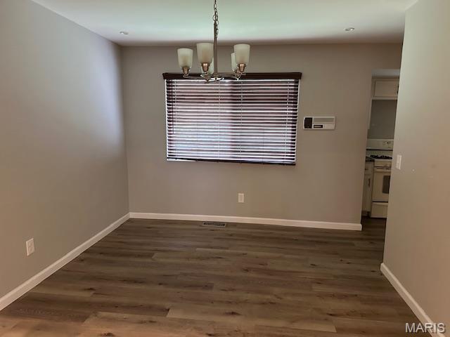 12750 Needle Point Ct, Florissant, MO 63033 - spare room featuring a chandelier and dark wood-type flooring