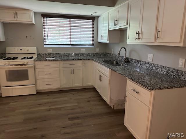 12750 Needle Point Ct, Florissant, MO 63033 - kitchen with white range with gas stovetop, dark wood-style floors, white cabinets, and dark stone countertops