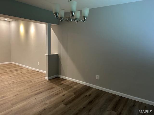 12750 Needle Point Ct, Florissant, MO 63033 - unfurnished dining area with wood finished floors and a chandelier